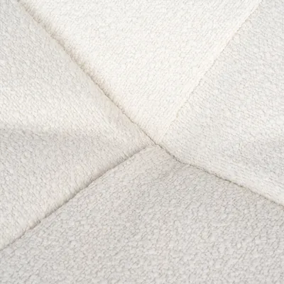 Primer plano de tela blanca texturizada con costura cruzada. El material muestra una superficie suave y esponjosa.