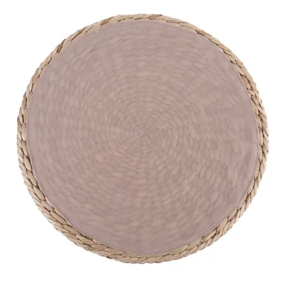Round scratching mat made of woven natural material with beige fabric cover in the centre.