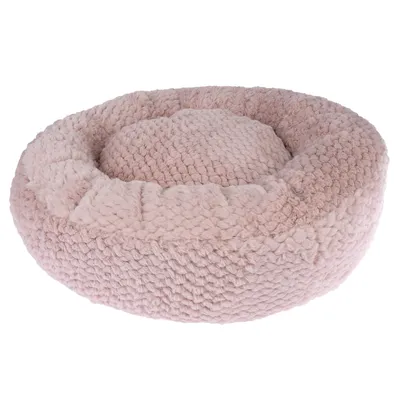 Panier rond en tissu rose clair à texture épaisse, rebords surélevés et coussin central intégré, sans marque visible.