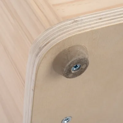 Close-up view of a rounded wooden corner with rubber feet and screw fastening.