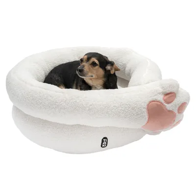 Dog in a white, plush pet bed with pink paw motif and TIA logo.