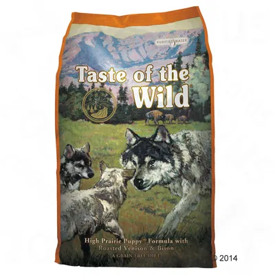 Balení s textem Taste of the Wild, High Prairie Puppy Formula with Roasted Venison & Bison, A Grain-Free Diet, obrázek vlků na louce, nápis Purified Water.