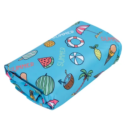 Folded blue mat with summer motifs such as watermelons, ice cream, sun umbrellas and coconuts. The text 'SUMMER' is visible multiple times.