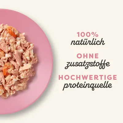 100% natürlich, ohne Zusatzstoffe, hochwertige Proteinquelle. Abgebildet ist zerkleinertes Fleisch auf einem rosa Teller.