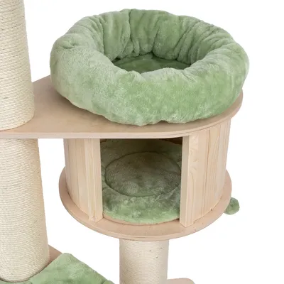 Cat tree made of wood with green plush bed on top and padded cave below. Sisal-wrapped posts for claw care visible.