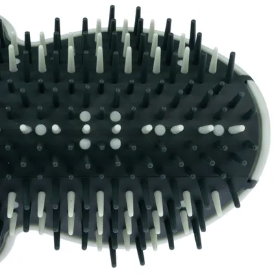Close-up of a black brush with white and black plastic bristles, suitable for coat care.