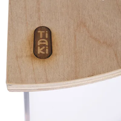 Tiaki logo on a wooden surface, visible in a product detail image.