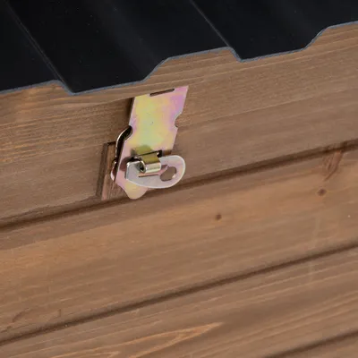 Detailný pohľad na drevený uzáver s kovovou sponou na drevenej debničke, viditeľné čierne veko.