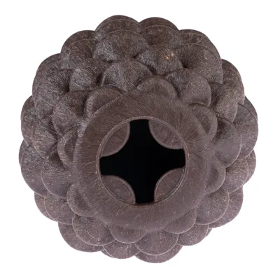 Brown toy made of coconut material with flower-shaped design and central cross slot for treats or interaction.