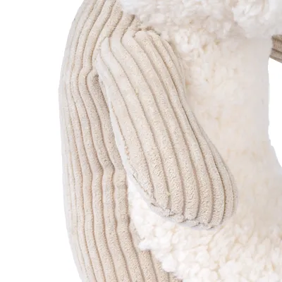 Close-up of a toy made of ribbed fabric and soft plush material in beige and white.
