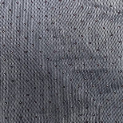 Close-up of grey fabric with small black dots, possibly material description for a product.