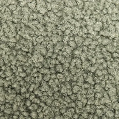 Gros plan sur une surface en tissu gris, structurée, avec une texture douce et laineuse.