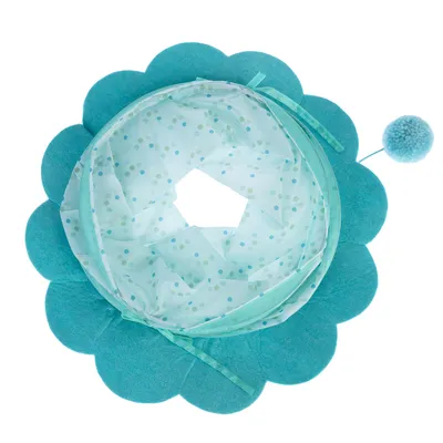 Toy in flower shape made of blue fabric with transparent polka dot pattern and pompom pendant.