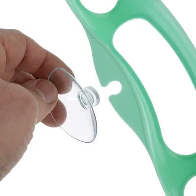 Mână arată fixarea unei ventuze transparente pe o ramă din plastic verde.