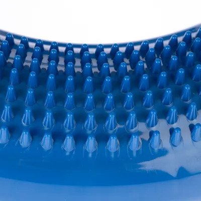 Close-up of blue plastic studs on a surface, possibly part of a massage or grooming product.