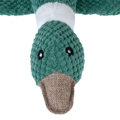 Jouet pour chien en forme de canard, tête en tissu vert texturé, bec en toile marron, col blanc visible. Aucun texte ou marque apparente.
