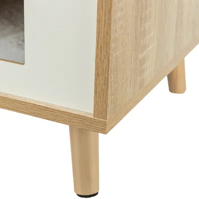 Close-up view of a piece of furniture with wood look, white side panels and round wooden legs.