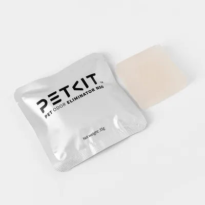 Sachet PETKIT PET ODOR ELIMINATOR N50, Net weight: 35g, avec un bloc solide beige à côté. Texte en anglais visible sur l'emballage.