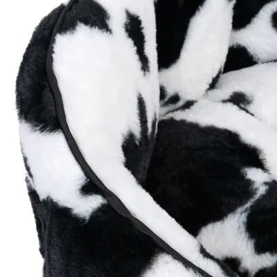Close-up of a black and white patterned, soft fabric material with plush texture and black edge.