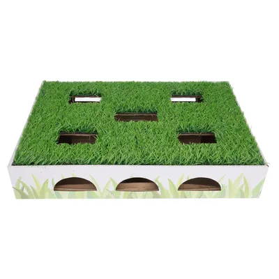 Cardboard play box with green lawn design, several rectangular openings on top and semicircular entrances on the sides.