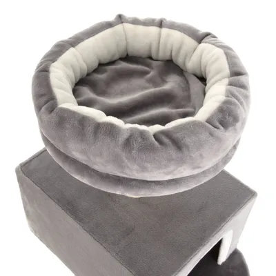 Niche pour chat en tissu gris et blanc, avec coussin rond sur le dessus et espace fermé en dessous. Matériau visible : tissu doux.