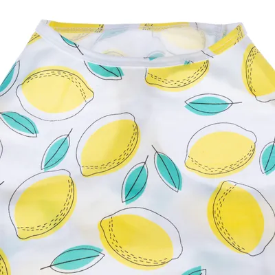 Tissu blanc avec motifs de citrons jaunes et feuilles vertes, couture visible au col. Matière textile clairement apparente.