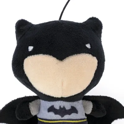 Black plush toy shaped like a superhero with a bat symbol on the chest.