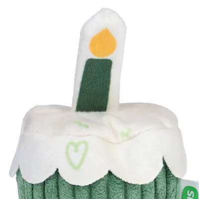 Toy in the shape of a green cupcake with a white candle and yellow flame, decorated with green heart motifs.