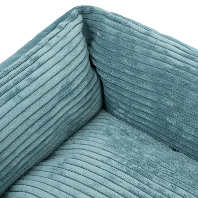 Primo piano di un materiale imbottito in tessuto con struttura a coste, colore turchese.