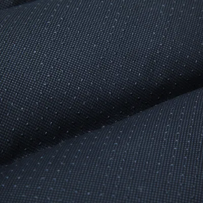 Detail van zwart textiel met antislip nopjes, materiaal close-up zichtbaar.