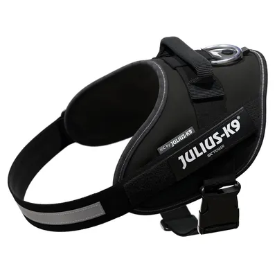 Black Julius-K9 IDC Power harness with reflective stripes and handle, suitable for dogs.