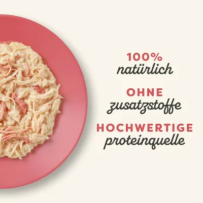 100% natürlich, ohne Zusatzstoffe, hochwertige Proteinquelle. Abgebildet ist ein Teller mit zerkleinertem Fleisch.