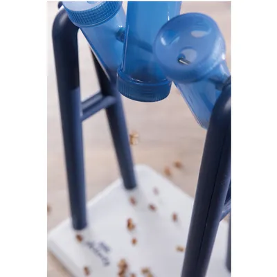 Toy with blue tubes and holes for food to fall through. Suitable for interactive play and reward training.