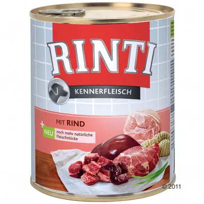 Lata de comida para perros Rinti Kennerfleisch, texto visible: 'MIT RIND', 'NEU noch mehr natürliche Fleischstücke', imagen de trozos de carne y órganos en el envase.