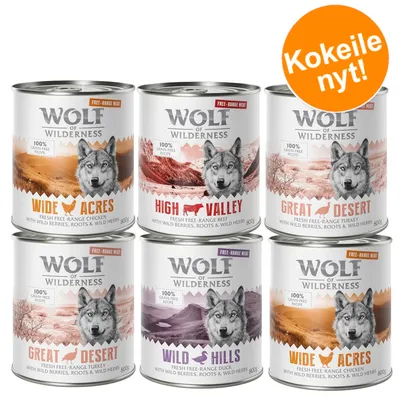 Wolf of Wilderness -koiranruokapurkit: Wide Acres, High Valley, Great Desert, Wild Hills. 800 g. Teksti: Kokeile nyt! 100 % grain free recipe, free-range meat, with wild berries, roots & wild herbs.