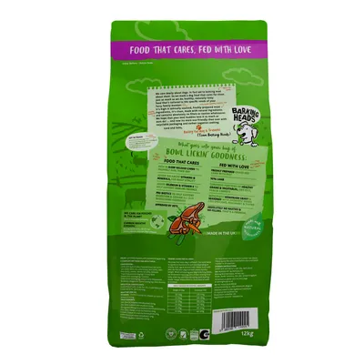 Back of pet food bag showing feeding guide, nutritional information, and product highlights such as freshly prepared lamb, added vitamins, no artificial nasties, and made in the UK.