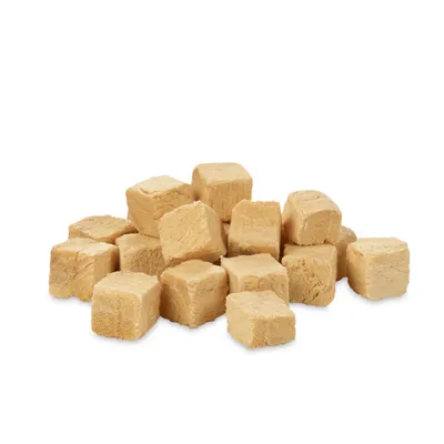 Light, cube-shaped treat pieces made from dried material, suitable as a snack or reward for pets.