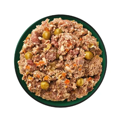 Bowl filled with chunky wet pet food containing visible pieces of meat, peas and carrots.