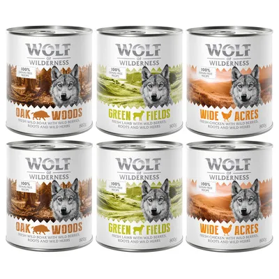 Wolf of Wilderness natvoer 800g: Oak Woods (wild zwijn), Green Fields (lam), Wide Acres (kip). Tekst: 100% grain-free recipe, met bessen, wortels en kruiden. Zes blikken zichtbaar.