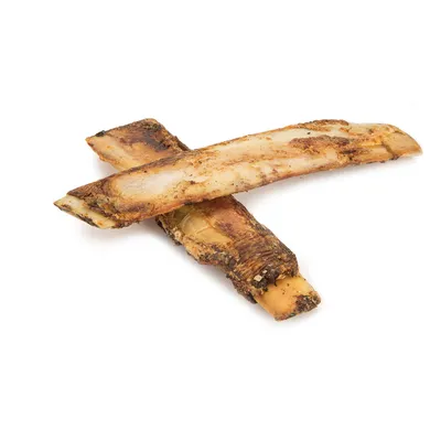 Two dried beef bones as a natural chew snack, brown and beige colouring.