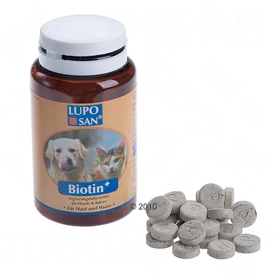Burk med LUPO SAN Biotin+ tabletter, etikett visar hund och katt samt texten 'für Haut und Haare', flera grå tabletter synliga bredvid burken.