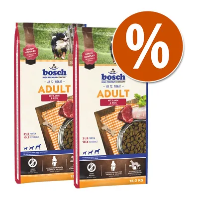2 sacos de Bosch Adult mit Lamm & Reis, 15 kg, visible: 21,5 % proteína, 10,5 % grasa. Imagen de croquetas y carne. Símbolo de porcentaje en círculo naranja.