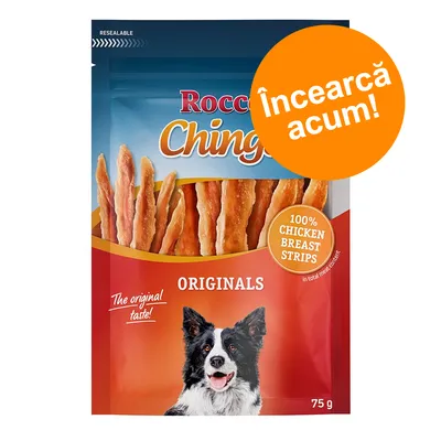 Pachet Rocco Chings Originals, 100% Chicken Breast Strips, 75 g. Text vizibil: „The original taste!”, „Încearcă acum!” și imagine cu un câine alb-negru pe ambalaj. Pachet Rocco Chings Originals, 100% Chicken Breast Strips, 75 g. Text vizibil: „The original taste!”, „Încearcă acum!” și imagine cu un câine alb-negru pe ambalaj.