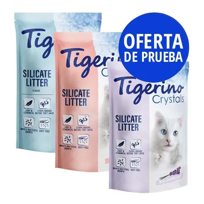Tres bolsas de arena de silicato Tigerino Crystals, texto visible: 'Silicate Litter', iconos de control de olores y polvo, oferta de prueba en círculo azul, variedad con lavanda.