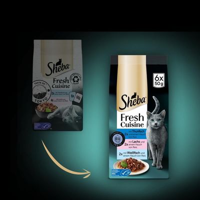 Две опаковки Sheba Fresh Cuisine Taste of Tokyo, нов и стар дизайн. Новата опаковка: 6x50 г, с риба тон, сьомга и бяла риба с ориз. Изображение на котка и купичка с храна.