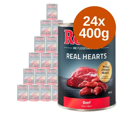Rocco Real Hearts Beef, 24 puszki po 400 g. Na etykiecie: z całymi sercami kurczaka, wołowina. Widoczne opakowania zbiorcze i pojedyncza puszka.