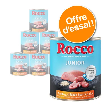 Lot de boîtes Rocco Junior 800 g, texte visible : Poultry, chicken hearts & rice. Offre d’essai ! Image de viande, cœurs de poulet et riz sur l’étiquette.