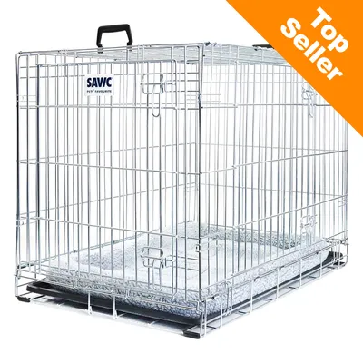 Savic metal pet crate with handle, visible bedding inside. Orange corner banner reads 'Top Seller'. PET'S FAVOURITE text under Savic brand name on front panel.