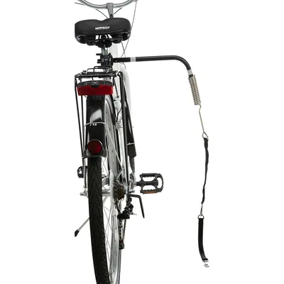 Cykel med monterat hundkoppelhållare, fjädermekanism och säkerhetsbälte för kontrollerad hundpromenad under cykling.