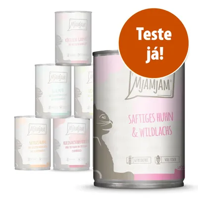 Várias latas de comida para gatos MjAMjAM, incluindo variedade 'Saftiges Huhn & Wildlachs'. Selo laranja com texto: Teste já!